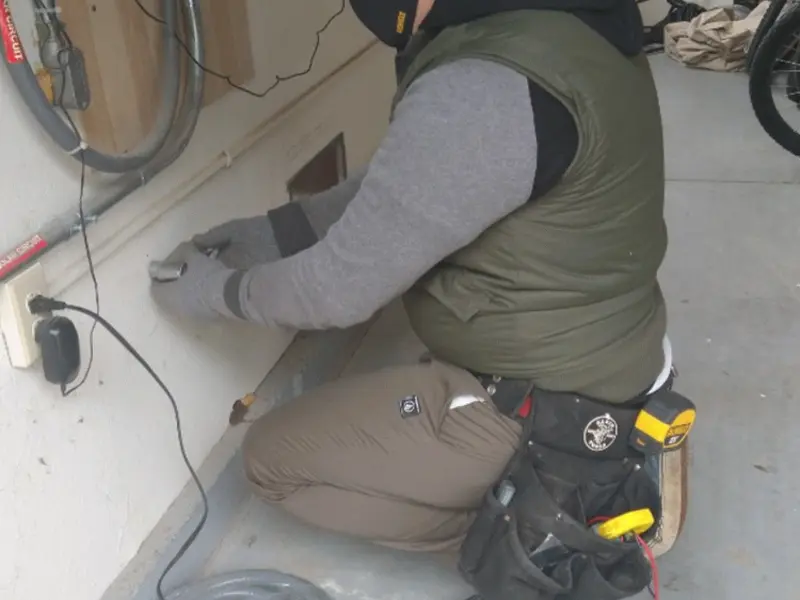 Electrician performing outlet wiring in a Crystal garage