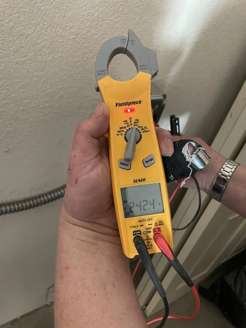 Voltage testing with clamp meter during Ceiling Fan Installation in Crystal